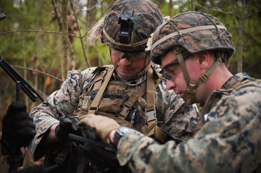 Marines using device in wooded area